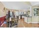 Spacious dining area seamlessly connects to kitchen, showcasing hardwood floors and ample natural light for comfortable living at 103 Manx Dr, Grantville, GA 30220