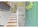 Inviting entryway featuring wooden stairs, a light grey color scheme, and a decorative wreath at 103 Manx Dr, Grantville, GA 30220
