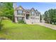 Charming home with a two-car garage, white stairs, and a manicured front yard at 103 Manx Dr, Grantville, GA 30220