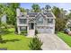 Charming home with a two-car garage, solar panels, and a well-manicured front yard at 103 Manx Dr, Grantville, GA 30220