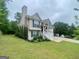 Well-maintained two-story home boasting a lush green lawn and convenient two-car garage at 103 Manx Dr, Grantville, GA 30220