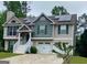 Two-story home featuring a lush green lawn, solar panels, and a convenient two-car garage at 103 Manx Dr, Grantville, GA 30220