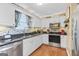 Bright kitchen boasts stainless steel appliances, granite countertops, and modern finishes for a chef's delight at 103 Manx Dr, Grantville, GA 30220