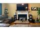 Inviting living room with a fireplace, cozy seating, and a large screen TV at 103 Manx Dr, Grantville, GA 30220