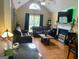 Cozy living room with vaulted ceiling, fireplace and a large window providing ample natural light at 103 Manx Dr, Grantville, GA 30220