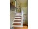 Inviting staircase featuring a blend of carpeted and wood steps, leading to upper level at 103 Manx Dr, Grantville, GA 30220
