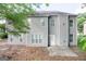 Backyard view of the home's gray siding and windows surrounded by green lawn at 3313 Bethesda Ter, Acworth, GA 30101