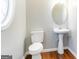 Bright bathroom features wood flooring and a pedestal sink beneath an oval mirror at 3313 Bethesda Ter, Acworth, GA 30101