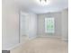 Bright bedroom featuring a window, neutral paint, and an open closet at 3313 Bethesda Ter, Acworth, GA 30101