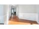 Bright hallway with hardwood flooring leading to a cozy living room with a fireplace at 3313 Bethesda Ter, Acworth, GA 30101