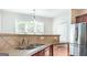 Charming kitchen with a stainless steel sink, wooden cabinets, stainless steel appliances, and lots of natural light at 3313 Bethesda Ter, Acworth, GA 30101