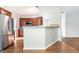 Spacious kitchen with stainless steel appliances, wooden cabinets, and a breakfast bar that overlooks the living room at 3313 Bethesda Ter, Acworth, GA 30101