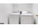 Laundry room with a white washer and dryer and wire shelving for storage at 3313 Bethesda Ter, Acworth, GA 30101