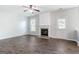 Bright living room features a fireplace, wood floors, and a ceiling fan at 3313 Bethesda Ter, Acworth, GA 30101