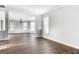 Open-concept living room with natural light, hardwood floors, and wainscotting at 3313 Bethesda Ter, Acworth, GA 30101