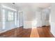 Bright living room showcasing hardwood floors, white trim, wainscoting, and a door that provides outdoor access at 3313 Bethesda Ter, Acworth, GA 30101