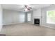 Living room features a fireplace, ceiling fan, and neutral carpet at 3313 Bethesda Ter, Acworth, GA 30101