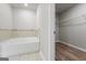A bathroom with a corner tub and walk-in closet, great for storage and relaxation at 8069 Louis Dr, Locust Grove, GA 30248