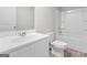 Bright bathroom with white fixtures including toilet, vanity, and bath with shower at 8069 Louis Dr, Locust Grove, GA 30248
