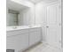 Bathroom featuring double sink vanity and walk-in shower at 8069 Louis Dr, Locust Grove, GA 30248