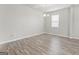 Cozy bedroom featuring a neutral color palette, wood-look floors, and a well-lit window at 8069 Louis Dr, Locust Grove, GA 30248