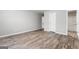 Spacious bedroom with neutral paint, wood-look floors, and adjacent bathroom access at 8069 Louis Dr, Locust Grove, GA 30248