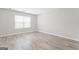 This bedroom has wood floors and a large window that lets in plenty of natural light at 8069 Louis Dr, Locust Grove, GA 30248