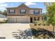 Beautiful two-story home featuring a three-car garage, brick and shingle facade, and a well-manicured front yard at 8069 Louis Dr, Locust Grove, GA 30248