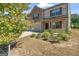 Beautiful two-story home with brick accents, a three-car garage, and mature landscaping at 8069 Louis Dr, Locust Grove, GA 30248