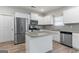 Modern kitchen with white cabinets, stainless steel appliances, granite countertops, and a stylish island at 8069 Louis Dr, Locust Grove, GA 30248