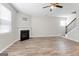 Comfortable living room features a fireplace, staircase, and wood-look floors for a cozy and inviting ambiance at 8069 Louis Dr, Locust Grove, GA 30248