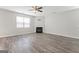 Inviting living room boasts wood-look floors, a decorative fireplace, and a ceiling fan, perfect for relaxation at 8069 Louis Dr, Locust Grove, GA 30248