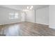 Bright living room features wood-look floors, a large window, and neutral paint, creating a welcoming space at 8069 Louis Dr, Locust Grove, GA 30248