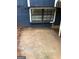 Exterior basement view of a window with bars in a dark blue painted wall with concrete ground around it at 1023 Falling Water Se Dr, Smyrna, GA 30080
