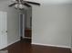 Spacious bedroom with hardwood floors, ceiling fan, and view into attached vanity at 1023 Falling Water Se Dr, Smyrna, GA 30080