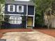 Two-story home with modern curb appeal, yellow door, and mature trees at 1023 Falling Water Se Dr, Smyrna, GA 30080