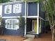 Charming blue two-story home with white trim, shutters, and a bright yellow front door at 1023 Falling Water Se Dr, Smyrna, GA 30080