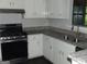Kitchen with white cabinets, granite countertops, stainless steel appliances, and modern fixtures at 1023 Falling Water Se Dr, Smyrna, GA 30080