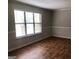 Bright living room featuring a large window and beautiful hardwood floors at 1023 Falling Water Se Dr, Smyrna, GA 30080