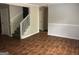 Open living room showcasing hardwood floors, stairs to the second floor, and ample space at 1023 Falling Water Se Dr, Smyrna, GA 30080