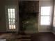 Living room with a stone fireplace, hardwood floors, and a glass door to the backyard at 1023 Falling Water Se Dr, Smyrna, GA 30080