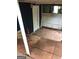 Enclosed patio area with a white door, a red fire extinguisher and weathered wood and tile flooring at 1023 Falling Water Se Dr, Smyrna, GA 30080