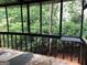 Enclosed back porch features screen walls and overlooks backyard at 1023 Falling Water Se Dr, Smyrna, GA 30080