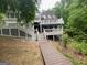 Spacious backyard featuring a multi-level deck and walkway, perfect for entertaining and outdoor enjoyment at 145 E Lake Dr, Mountain Park, GA 30075