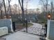 View of the property entrance featuring a decorative iron gate and stylish outdoor lighting fixtures at 145 E Lake Dr, Mountain Park, GA 30075