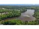Stunning aerial view of a serene lake surrounded by lush green trees and beautiful homes at 335 Discovery Lake Dr, Fayetteville, GA 30215