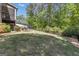Lush, green backyard with mature trees and partial fencing, offering a serene outdoor environment at 335 Discovery Lake Dr, Fayetteville, GA 30215