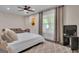 This bedroom features a ceiling fan, neutral walls, and a seating area in the room at 335 Discovery Lake Dr, Fayetteville, GA 30215