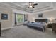 Large primary bedroom with trey ceilings, a ceiling fan, and a window for natural light at 335 Discovery Lake Dr, Fayetteville, GA 30215