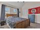This bedroom features a wooden sleigh bed, neutral walls, and two windows with natural light at 335 Discovery Lake Dr, Fayetteville, GA 30215
